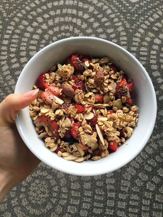 Healthy quinoa bowl with quinoa, 1/2 tbsp of honey, 1/4 cup of almond milk, blueberries, strawberries, bananas, 1/2 tbsp of almonds, 1/2 tsp of chia seeds, 1 tbsp of vanilla granola, 1/4 tsp of honey to top it with!